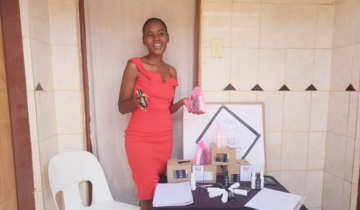 Shari, a project participant from Lesedi la Batho shows off her perfume business