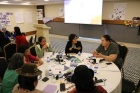 Group of UN Trust Fund grantee organizations representatives sitting around a table during a workshop