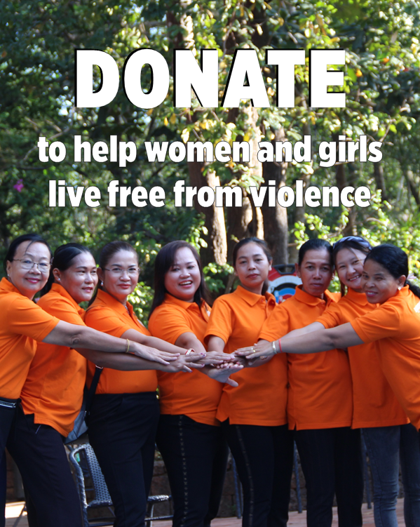 photo of a group of women wearing orange tshirts putting their hands together in solidarity and the text reads Donate to help women and girls live free from violence