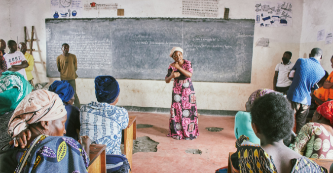Young woman speaking to a class of people