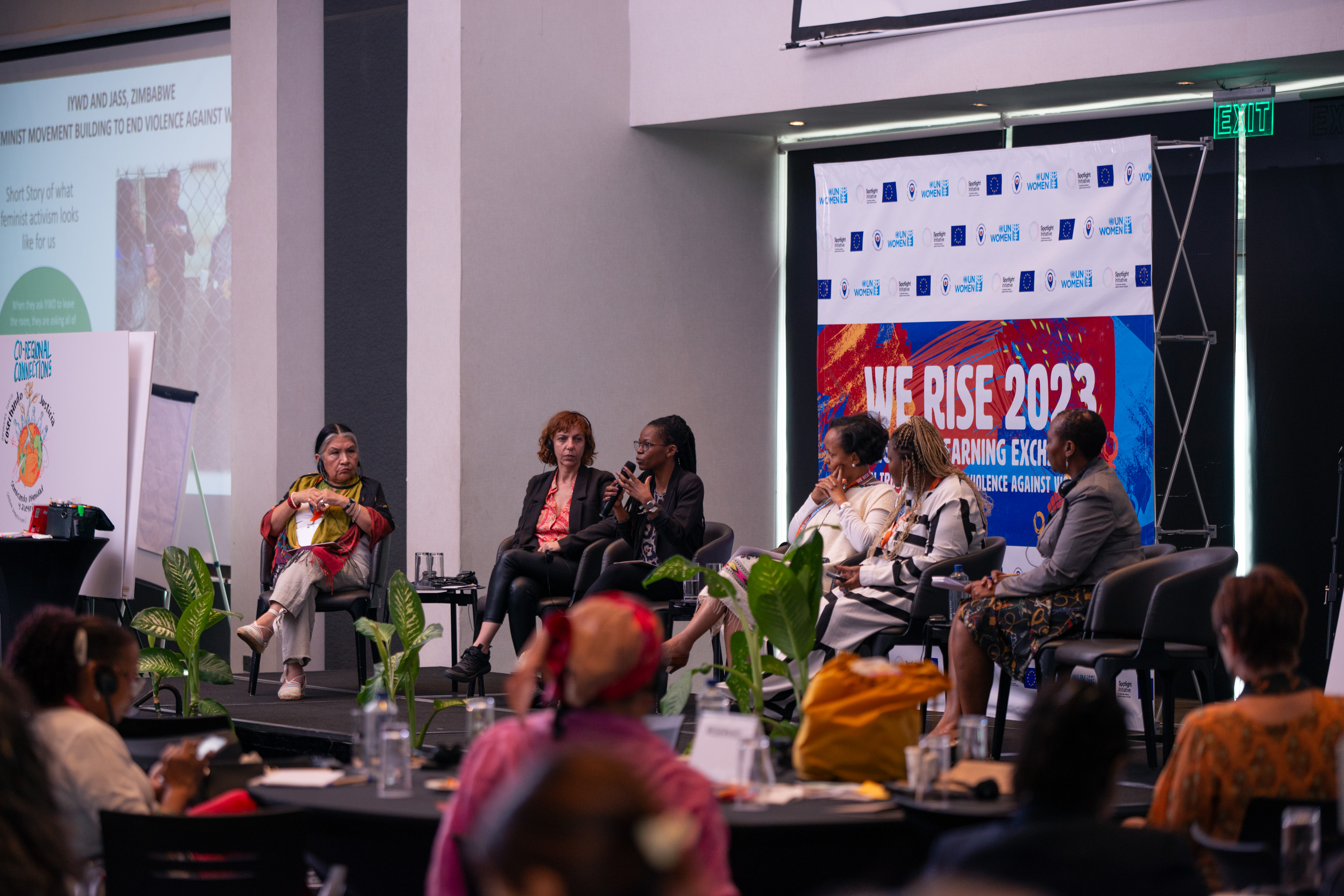 Panel of women sitting on a stage at We Rise 2023
