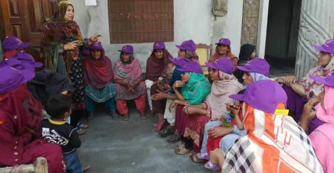 Farah Batool, a member of a community action group in Pakistan speaks about gender-based violence to women in Punjab, Pakistan. Photo: Shirkat Gah - Women's Resource Centre